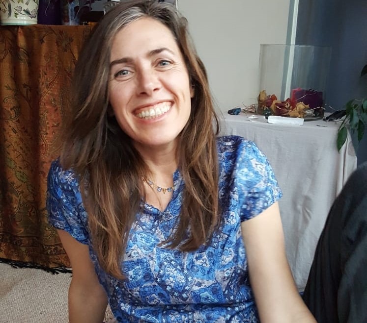 Sarah Ellington, smiling, in her treatment room